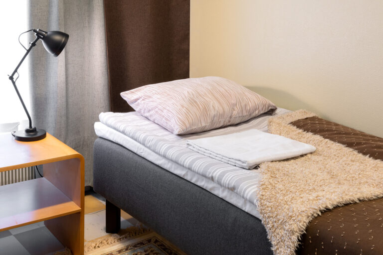 Bed with pillow. Furnished apartment